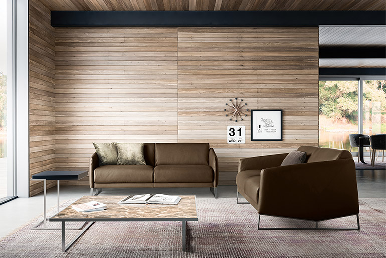 tavolino icaro con piano in marmo emperador e struttura in metallo, servoquadro tavolino con piano in laccato lavagna e struttura in metallo. Divano due posti Asolo in pelle design Emilio Nanni per Pianca