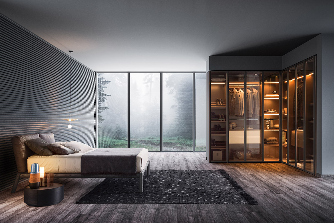 armadio angolare su misure con ante in vetro trasparente, letto dioniso in legno massello, comodino rotondo dedalo, tappeto teseo tessoria asolana Pianca