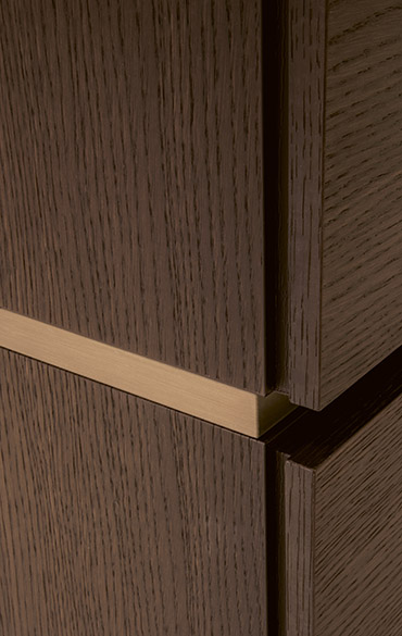 dettaglio cassettiera legno borgogna con distanziale bronzo Pianca